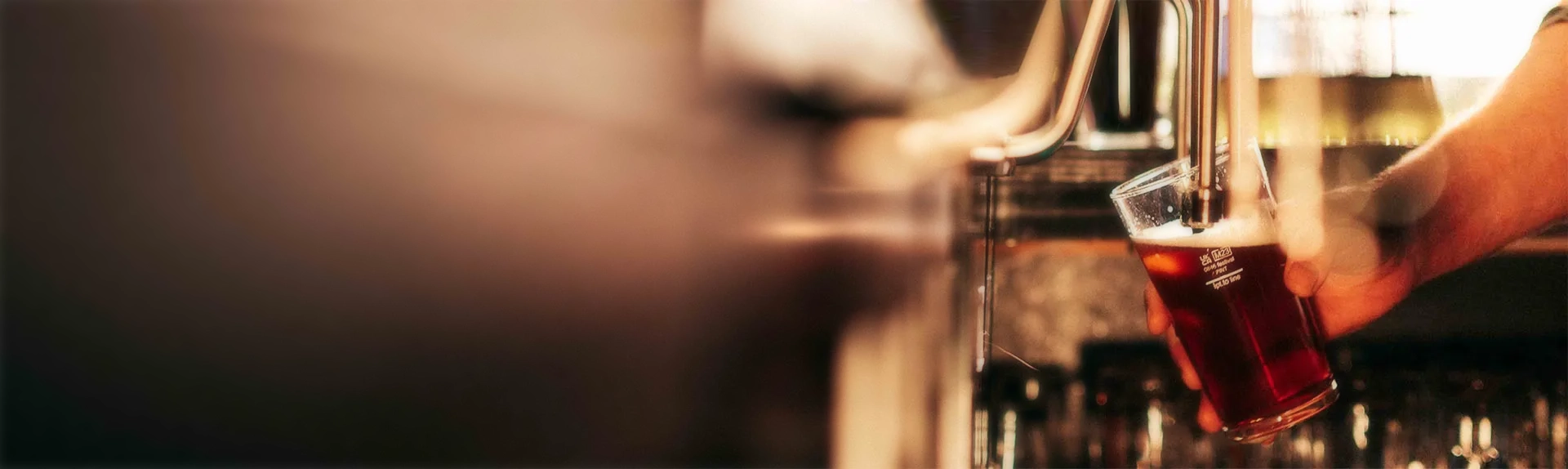 Bartender pouring beer from a beer pump